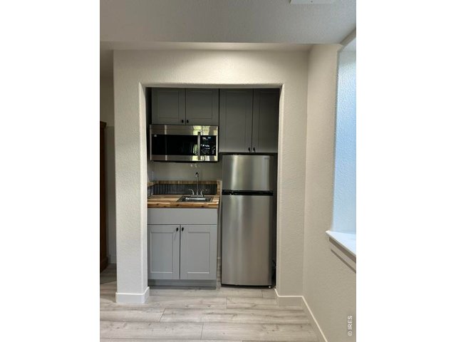 Property Photo 25 Kitchenette with wood counter top and metal backsplash. All appliances included.