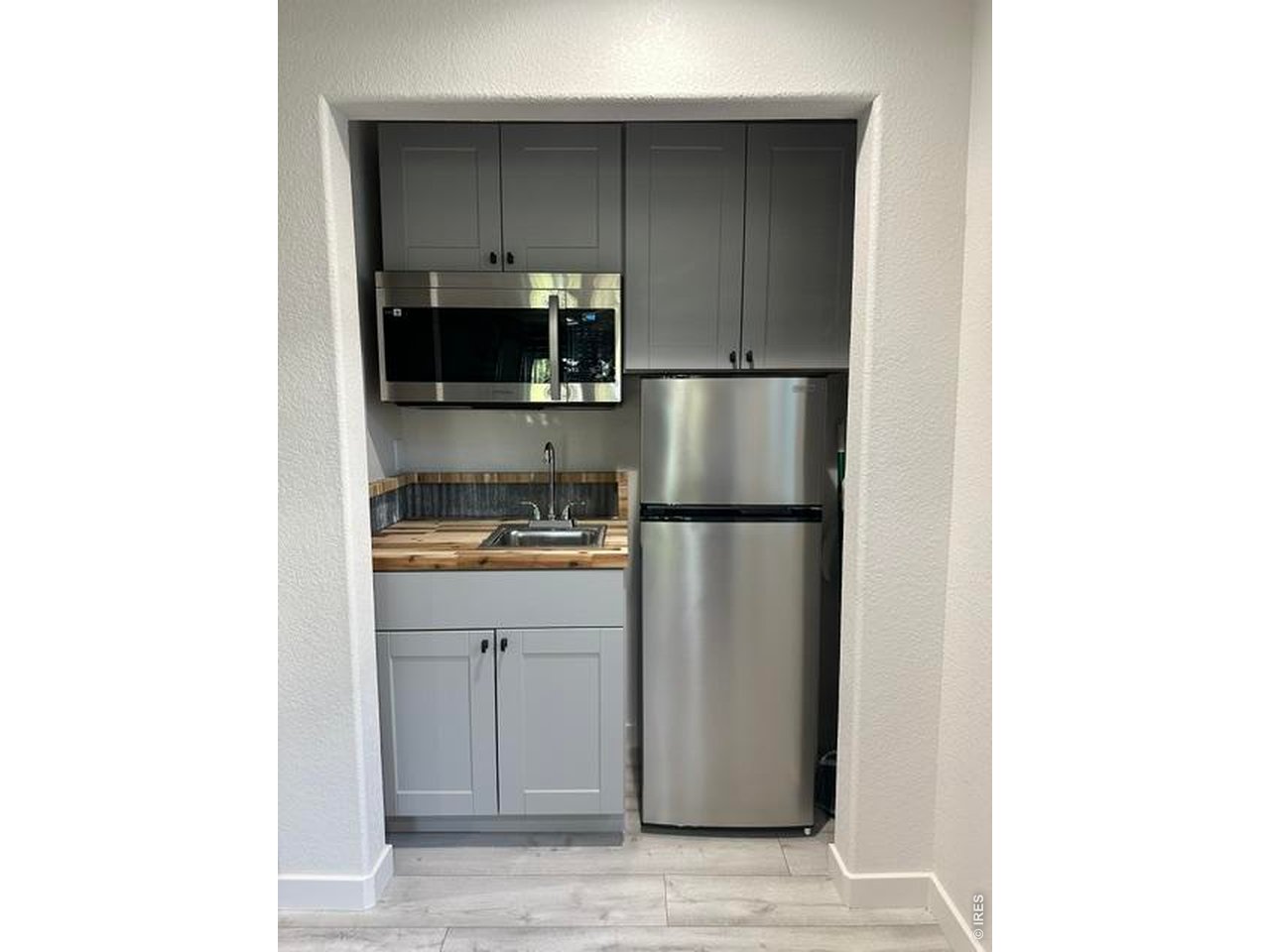 Property Photo 26 Kitchenette with sink, microwave and refrigerator. All appliances stay.