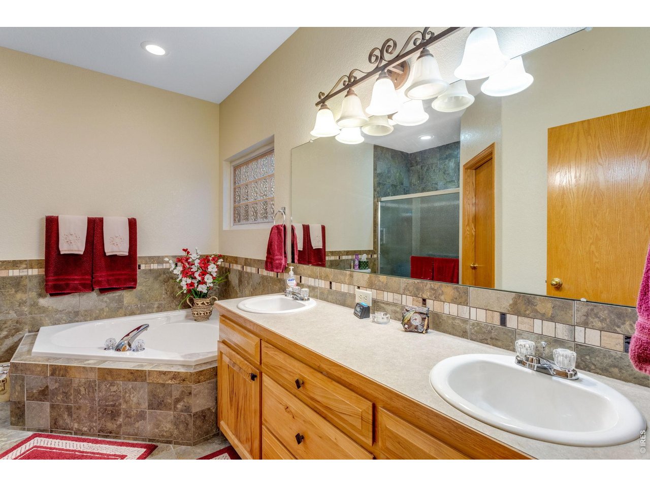 Property Photo 20 Full bath featuring a raised vanity, tile flooring, and tile backsplash
