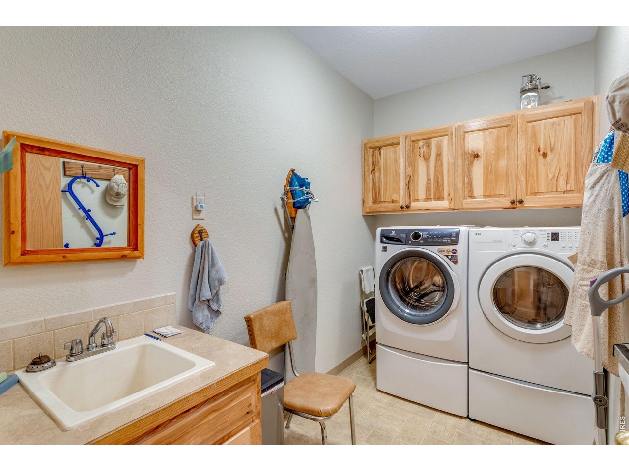 Property Photo 32 Laundry room off the garage featuring hickory cabinets and a utility sink