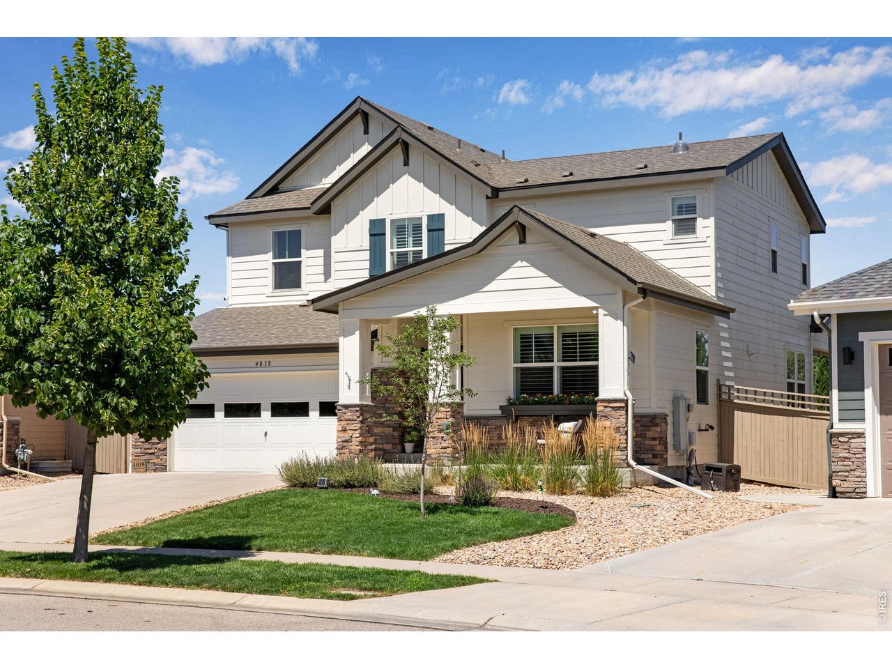Property Photo 4 Oversized finished 2 car garage, at 27 ft long with stunning epoxy floors and utility cabinetry & workbench. Fresh exterior paint 2024.