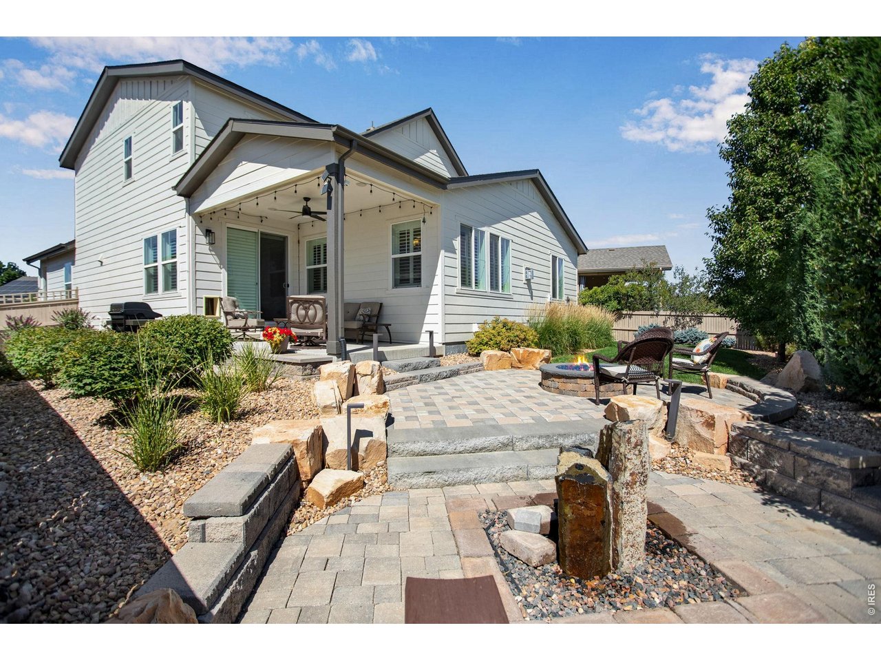 Property Photo 5 Stunning Custom/Professional landscaping. A true backyard Oasis, covered back patio with speakers and front porch has built-in speakers too! Waterfall feature and spacious gas firepit!