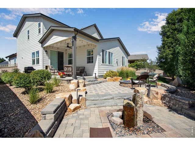Property Photo 5 Stunning Custom/Professional landscaping. A true backyard Oasis, covered back patio with speakers and front porch has built-in speakers too! Waterfall feature and spacious gas firepit!