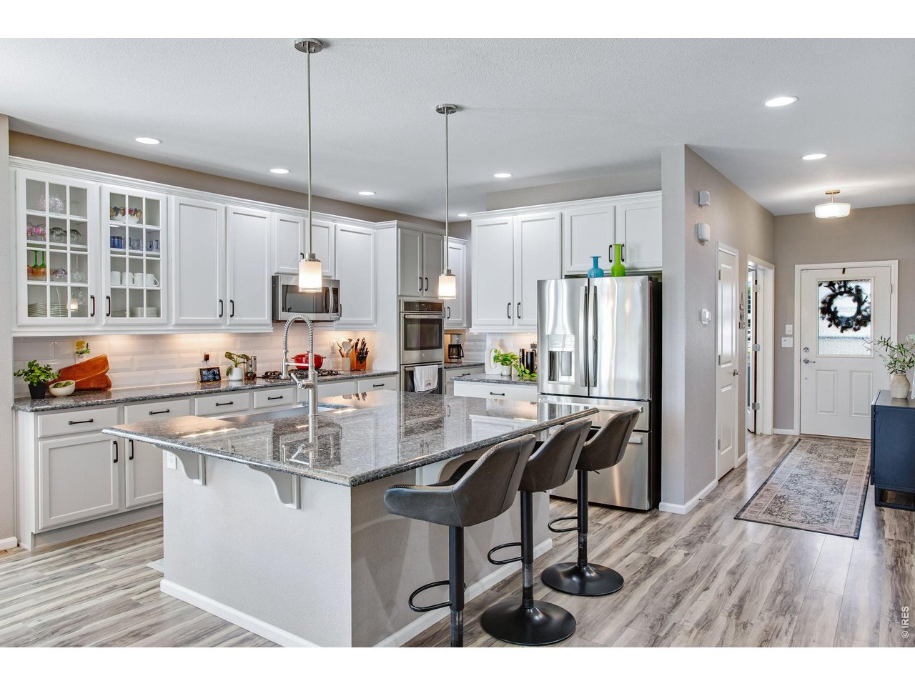 Property Photo 10 Check out this amazing Eat-in Kitchen, massive center island, freshly painted cabinetry, all soft close with dove-tail joints and newer cabinetry hardware.