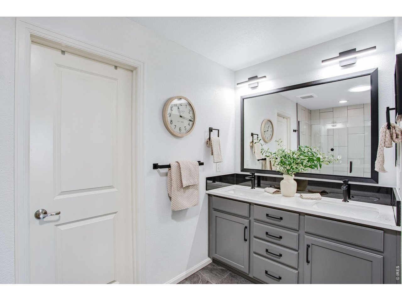 Property Photo 35 Double sinks, new shiny Quartz, painted cabinetry, large format tile flooring.