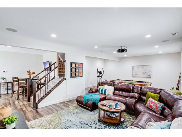 Property Photo 41 Fully Finished Lower Level - at 1,358 SF finished, stunning basement finished - well equipped with higher ceilings, wood laminate flooring and could a wonderful space for a secondary home office!