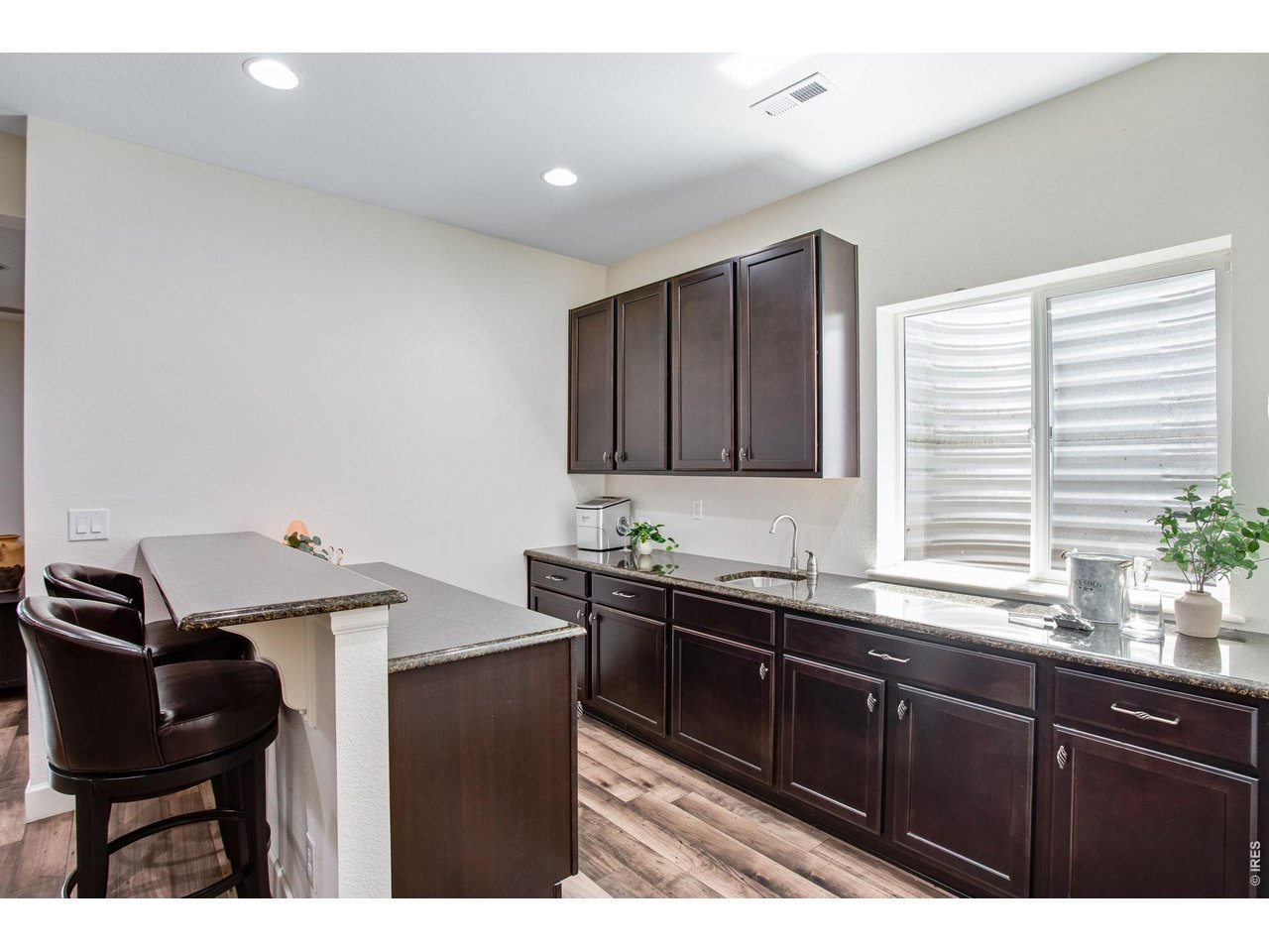 Property Photo 44 Shiny granite wet bar - loaded with cabinetry and countertop space!