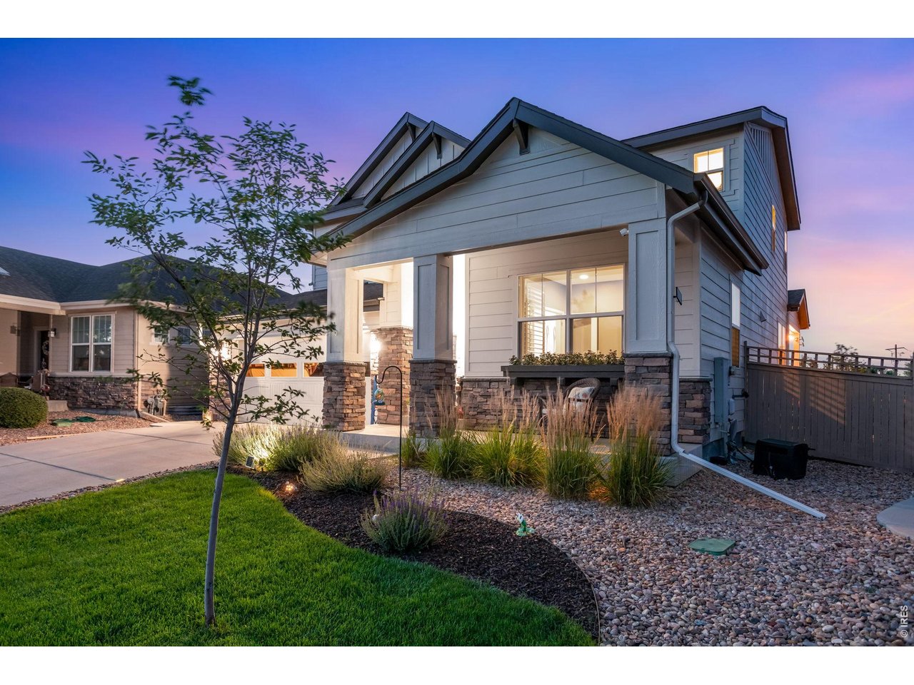 Property Photo 8 Manicured and idyllic south facing exposure! Oversized Milgard windows covered front porch across from HOA protected open space.