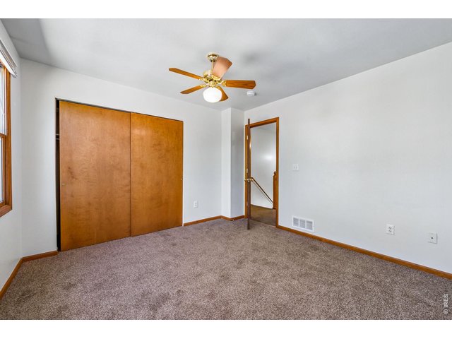 Property Photo 17 Primary bedroom with ceiling fan
