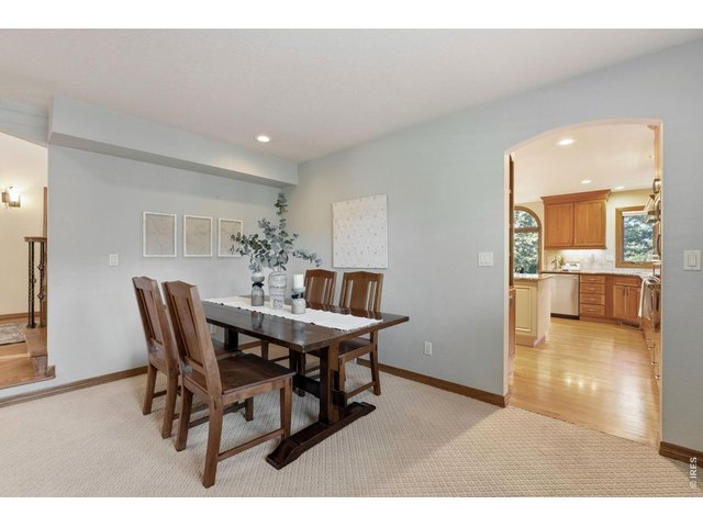 Property Photo 8 Formal Dining Room Elegant dining space flows seamlessly into the gourmet kitchen, perfect for entertaining
