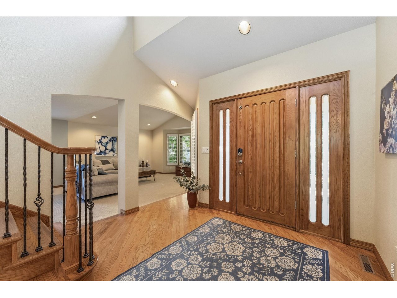 Property Photo 4 Step inside this grand entry to soaring ceilings, warm hardwood floors, and a spacious foyer that sets the tone for the rest of the home.