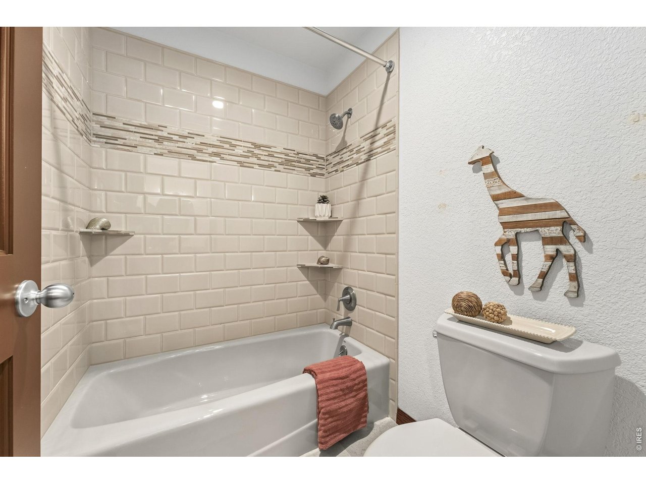 Property Photo 32 Clean, bright, and beautifully finished with timeless tile surround.
