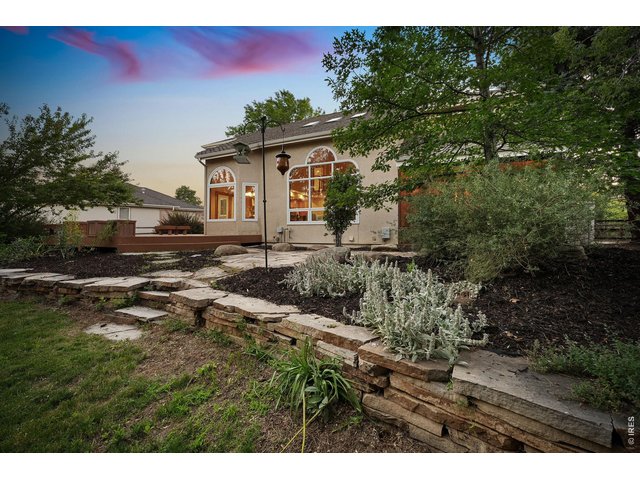 Property Photo 45 Thoughtfully landscaped with mature trees, stone pathways, and inviting outdoor living spaces.