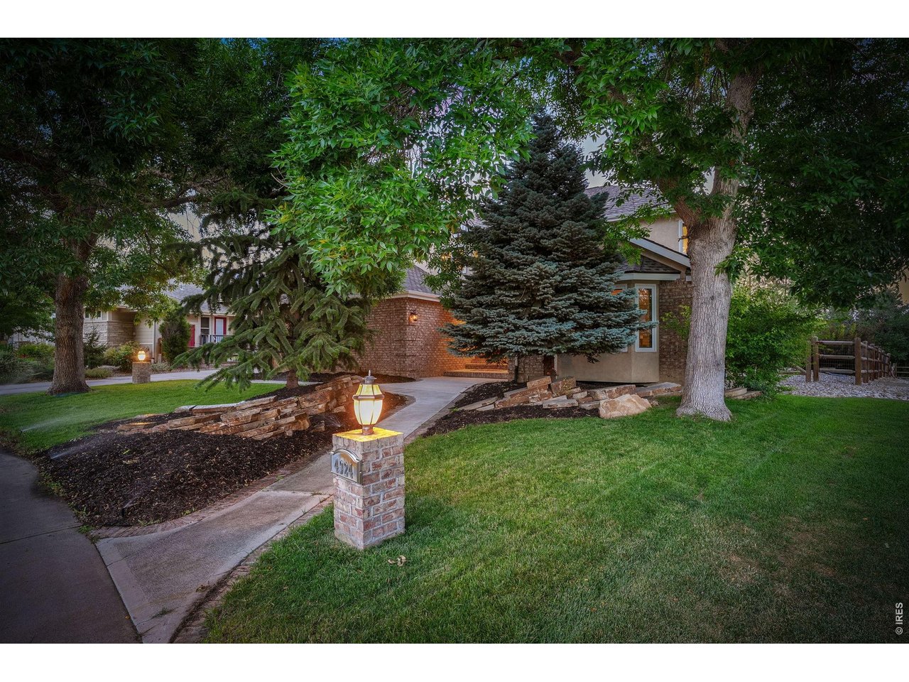 Property Photo 2 Mature trees, lush landscaping and a charming walkway create a warm welcoming home.
