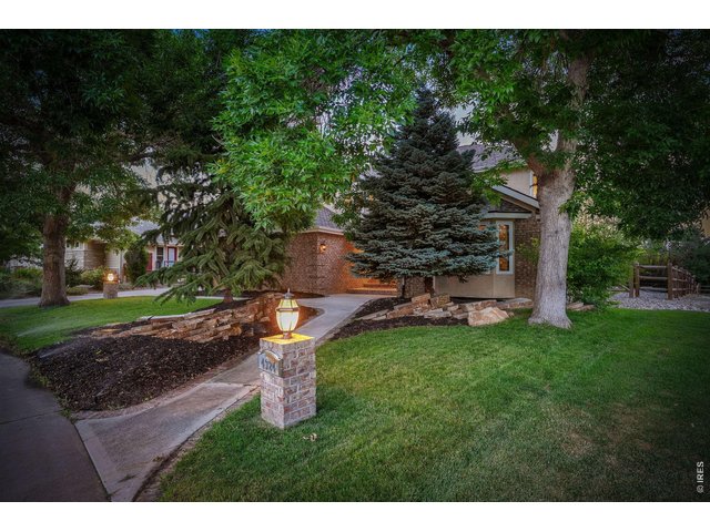 Property Photo 2 Mature trees, lush landscaping and a charming walkway create a warm welcoming home.