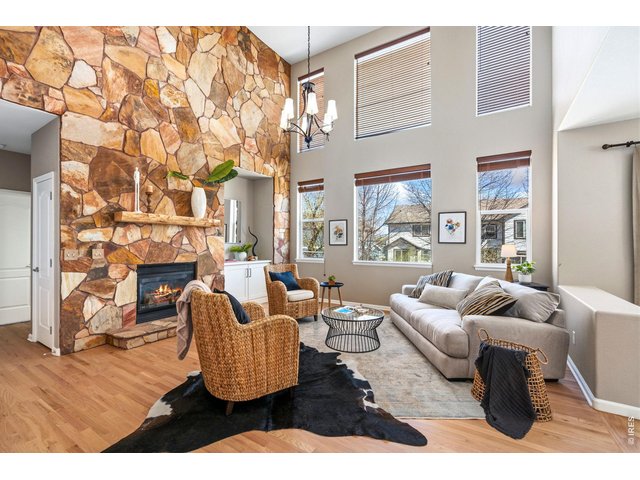 Property Photo 5 Open living with commanding flagstone fireplace and mantel.