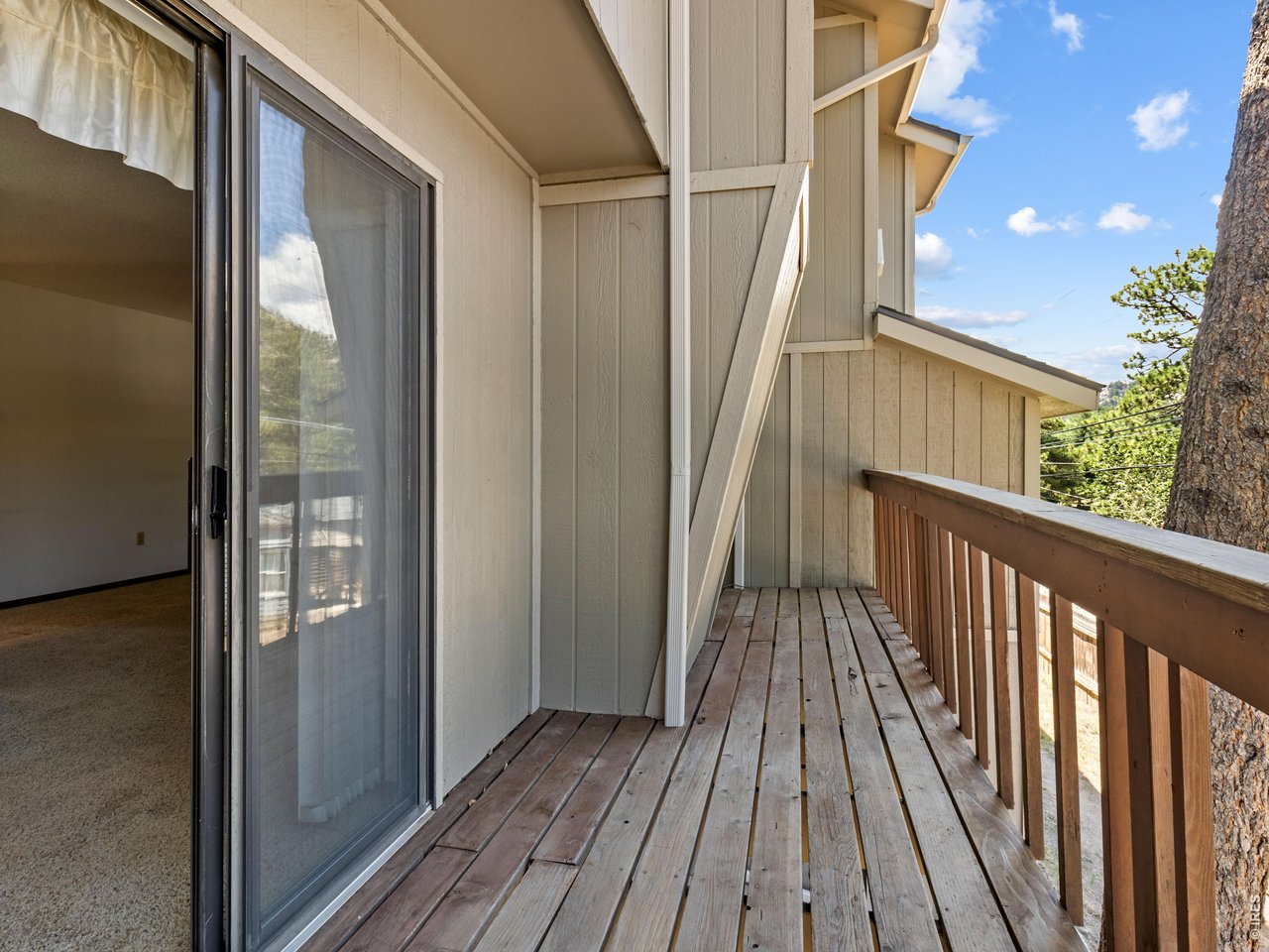 Property Photo 7 Enjoy mountain living from your private deck -ideal for morning coffee, outdoor dining, or simply taking in the fresh alpine air