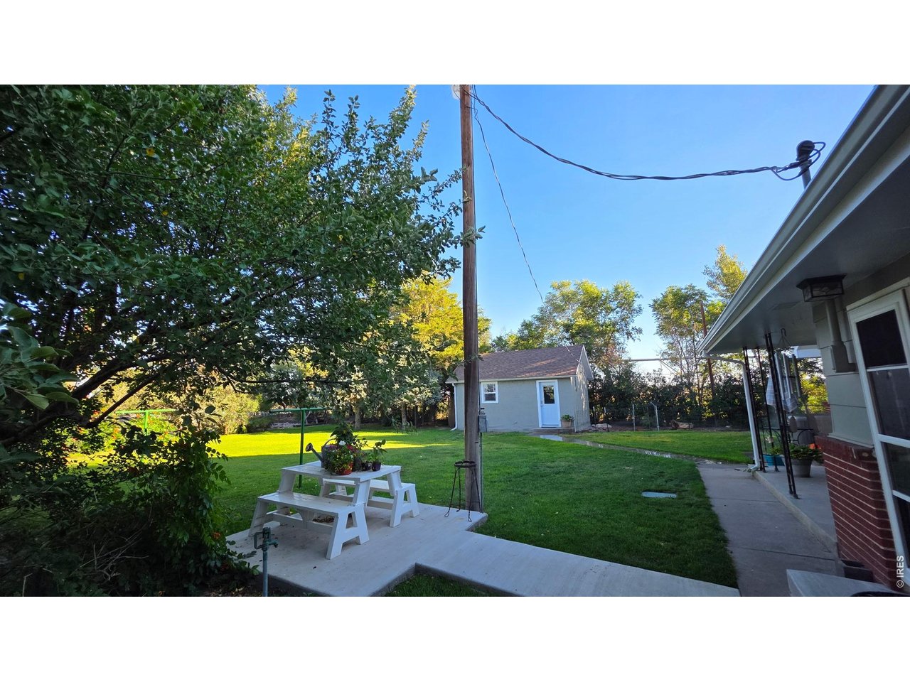 Property Photo 32 New concrete patio/back yard w/mature trees & dog run