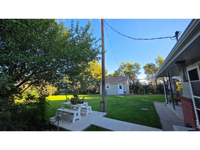 Property Photo 32 New concrete patio/back yard w/mature trees & dog run