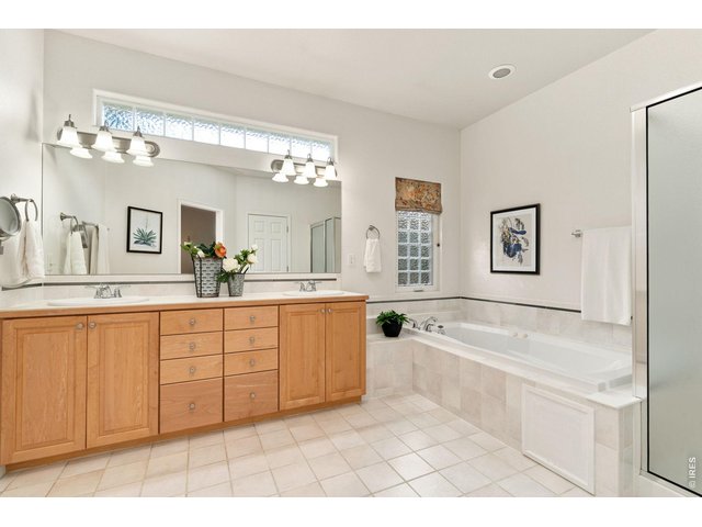Property Photo 19 5-piece primary bathroom with dual sinks.