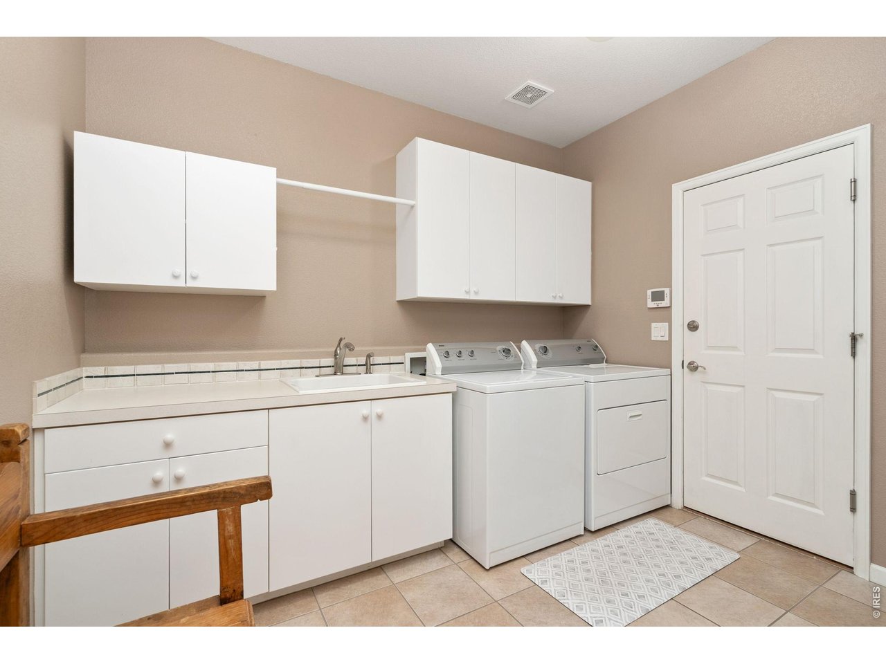 Property Photo 15 Huge laundry off garage into kitchen with counter, cabinets, and sink.