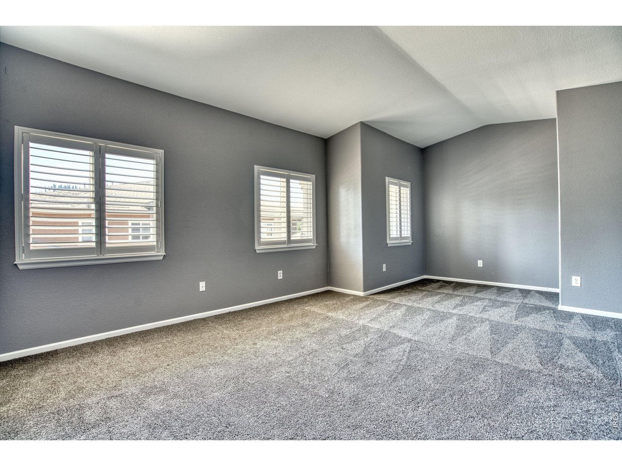 Property Photo 20 Primary bedroom suite offers a sitting area/desk space & vaulted ceiling.