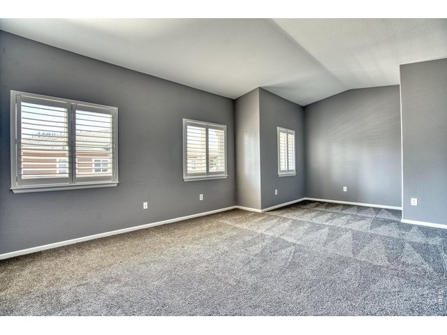 Property Photo 20 Primary bedroom suite offers a sitting area/desk space & vaulted ceiling.