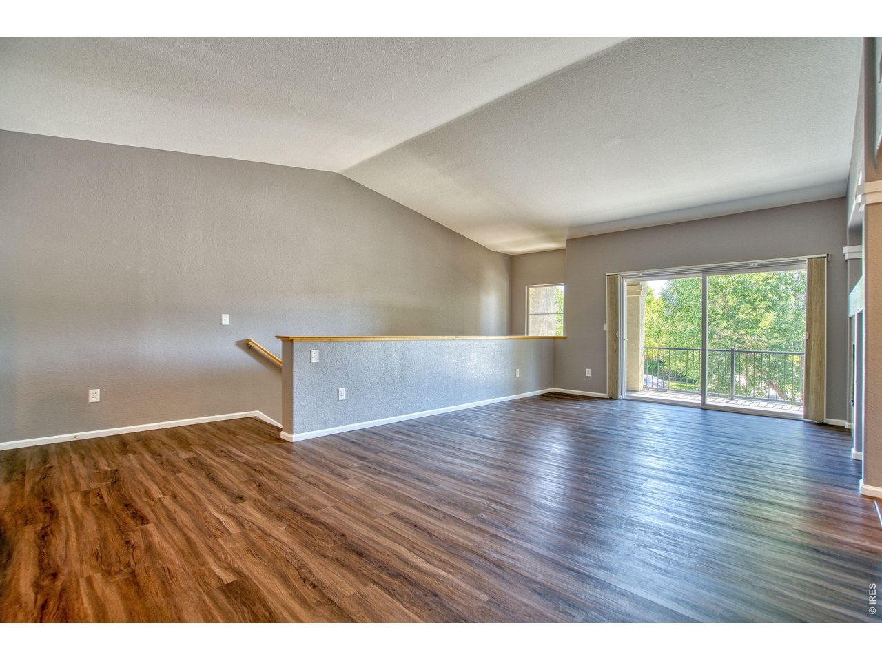 Property Photo 9 Extensive luxury vinyl floors in the living area, cathedral ceilings for a more spacious feel & neutral palette throughout.