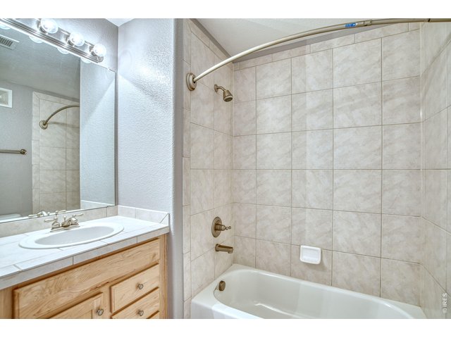 Property Photo 15 Full hall bathroom is near secondary bedrooms.