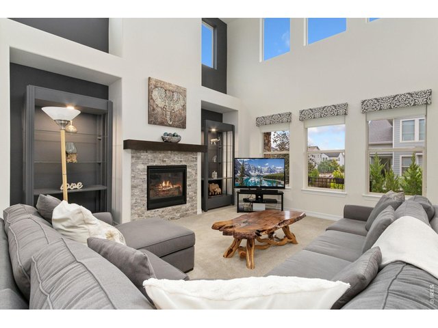 Property Photo 11 Great room, with fireplace and lots of light streaming in from one and two story windows.