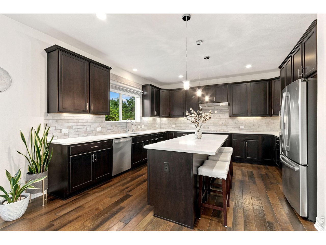 Property Photo 16 Spacious eat in kitchen with quartz counter tops, chocolate cabinets, beautiful backsplash and large island.