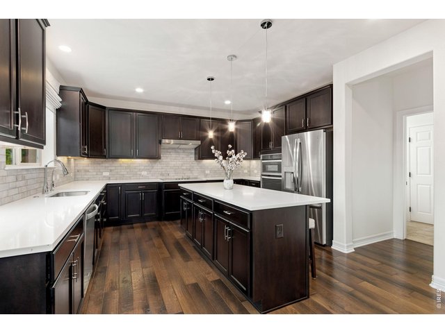 Property Photo 19 Kitchen with ample counter and cabinet space. Kitchen entry connects to great room, laundry room.