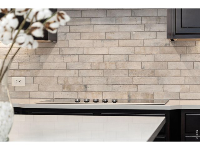 Property Photo 18 Kitchen offers a glass top easy to clean electric stove and beautiful backsplash.