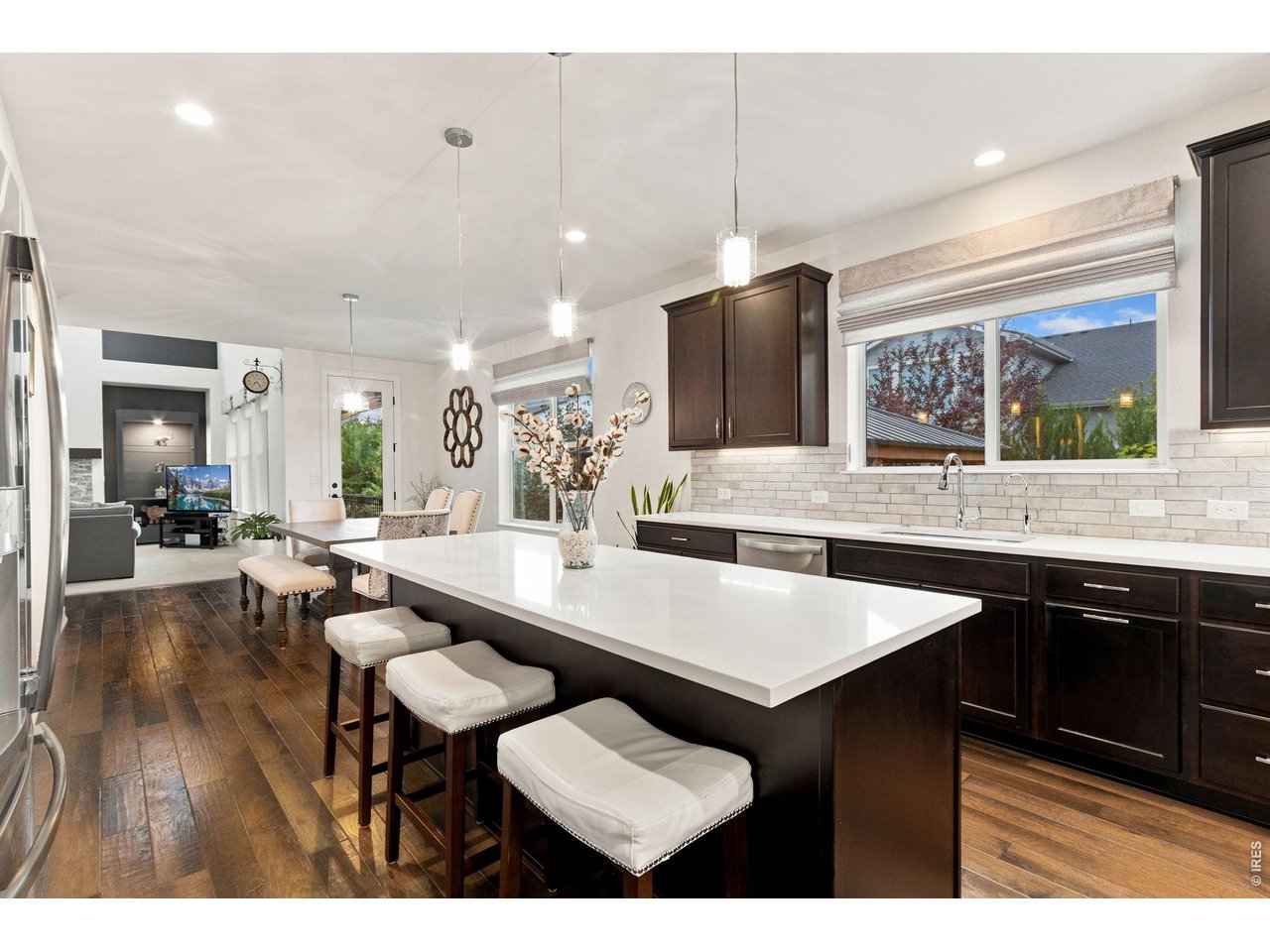 Property Photo 13 Eat in kitchen offers expansive quartz island with extra space for dining.