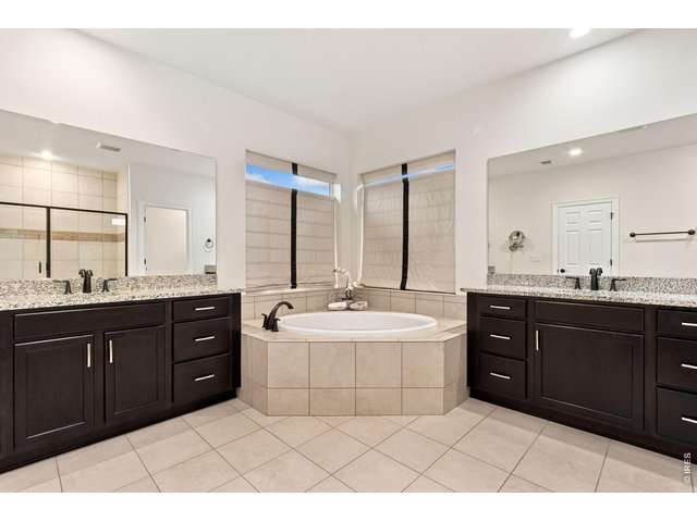 Property Photo 27 Primary ensuite five piece bathroom, with dual sinks and a soaking tub.
