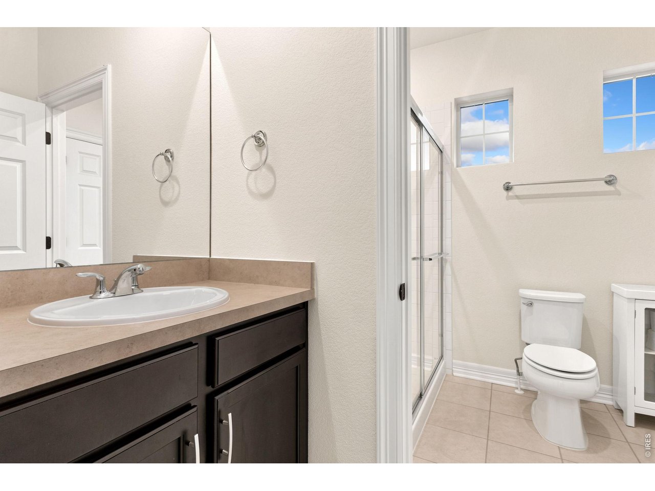 Property Photo 33 Upstairs bathroom pairs with second and third bedrooms. Dual sinks and step in shower.