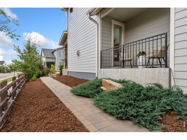 Property Photo 46 Corner lot side yard with beautiful pavers and cozy side porch that leads into the main floor great room.