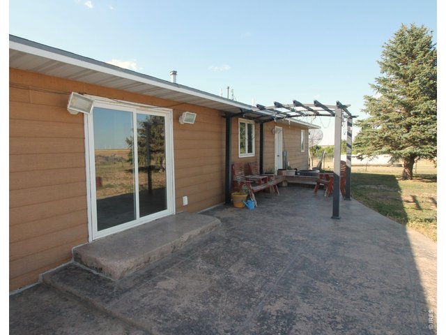 Property Photo 18 East patio off kitchen looking north