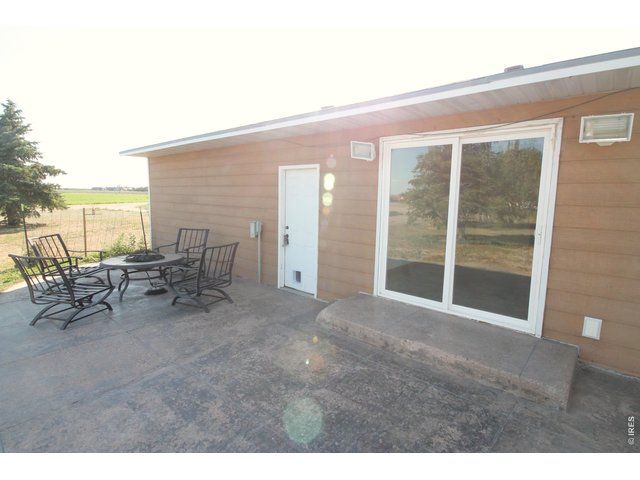 Property Photo 17 East patio off kitchen looking south