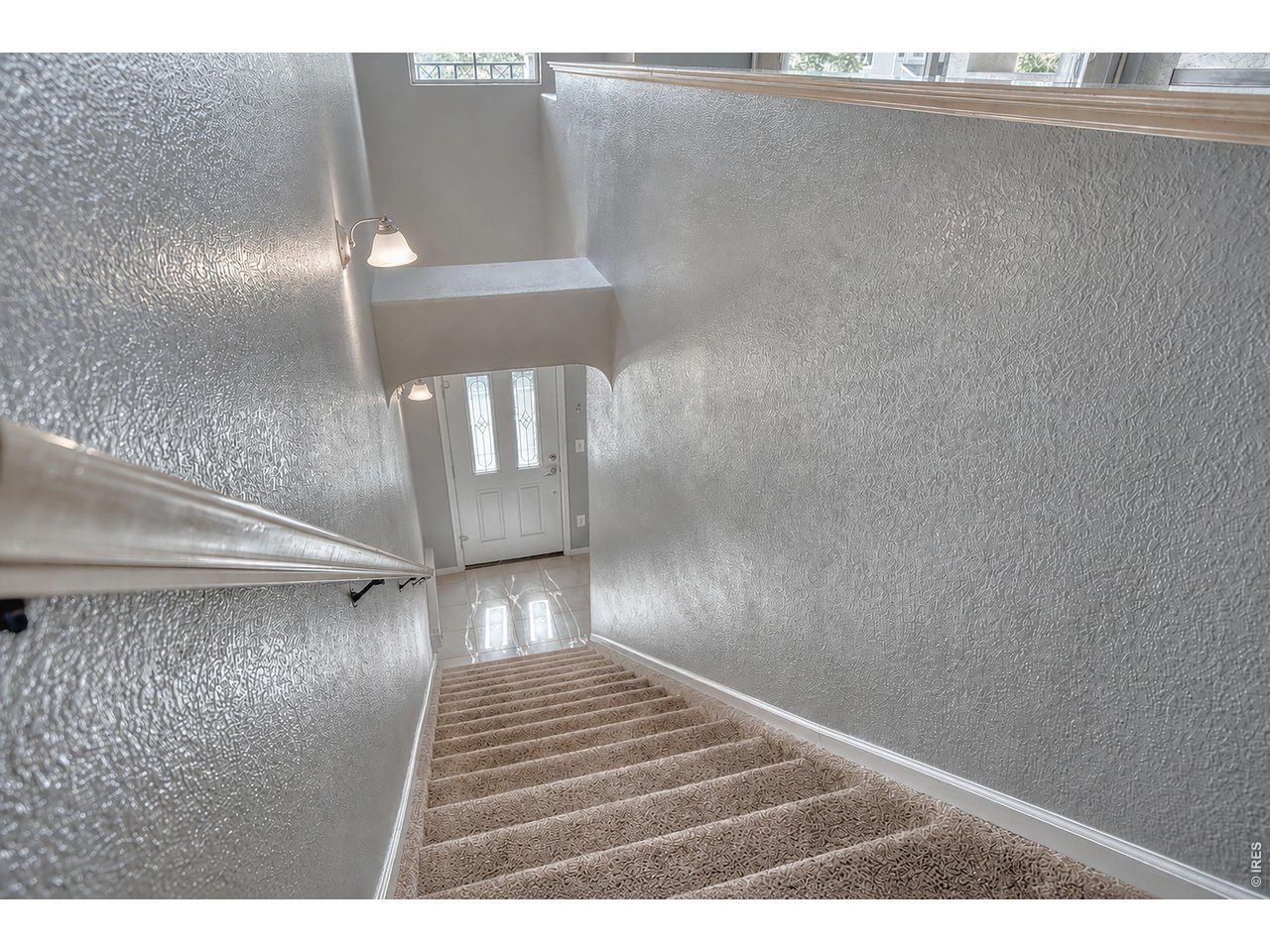 Property Photo 3 Outside entry with additional access from garage to inside the home. The home offers new carpet.