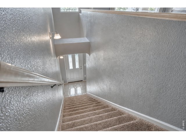 Property Photo 3 Outside entry with additional access from garage to inside the home. The home offers new carpet.