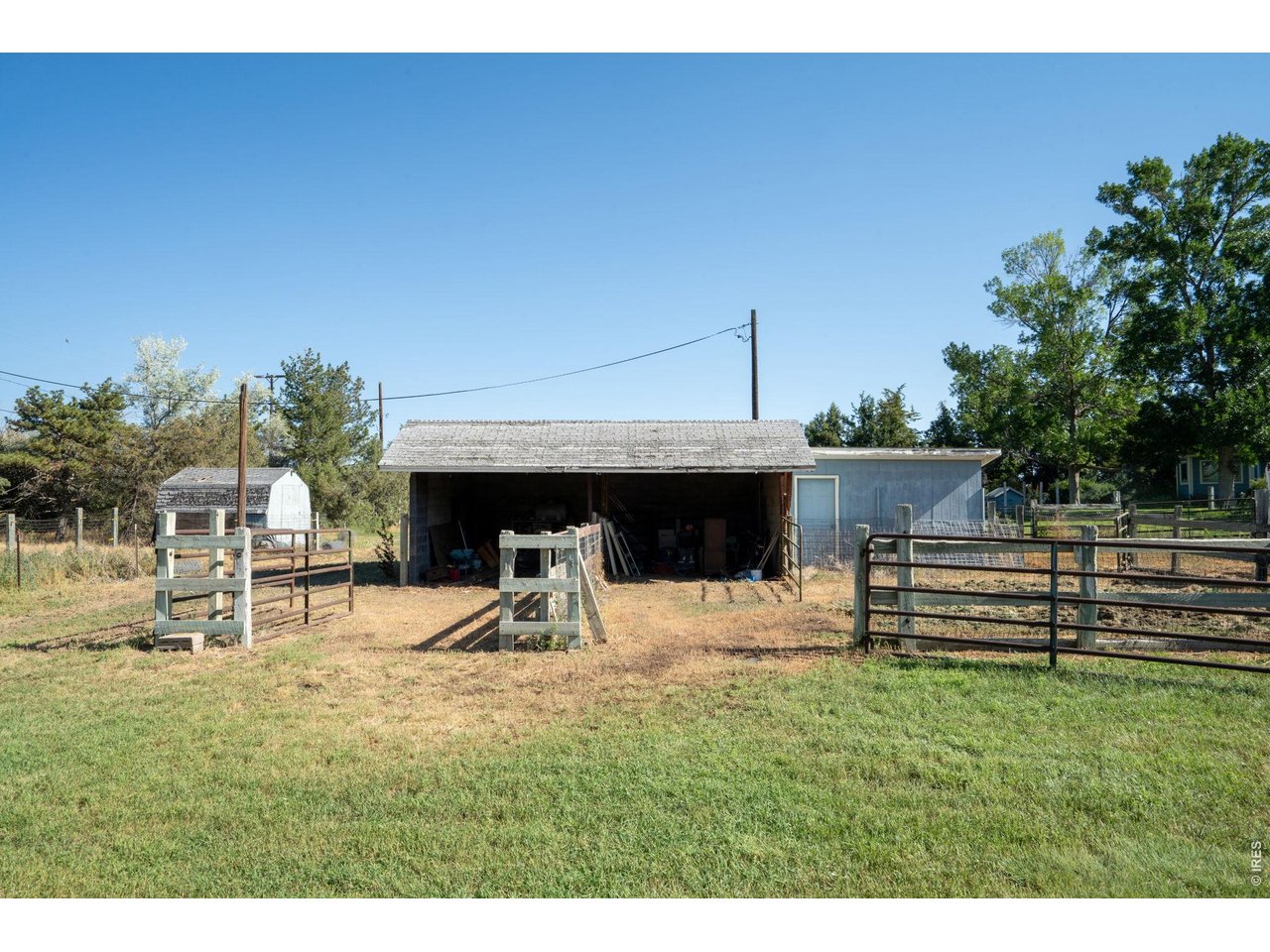 Property Photo 3 Loafing shed with 2 corrals and attached storage building.