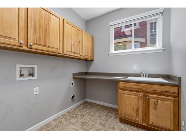 Property Photo 18 Main floor laundry room with sink and cabinets!