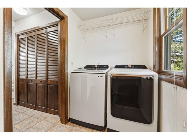Property Photo 20 Laundry room with storage, natural light, and built-in cabinetry for added convenience.