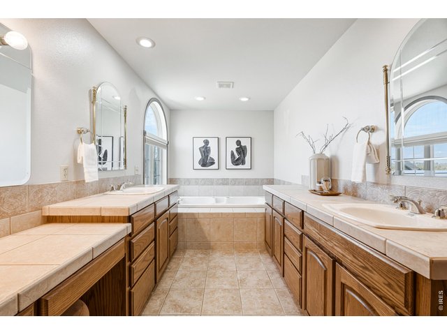 Property Photo 23 Spacious ensuite bath with dual vanities and soaking tub.