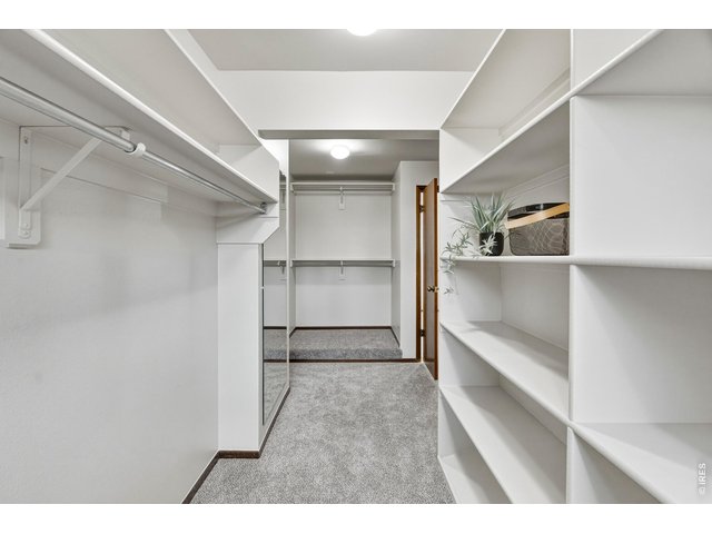 Property Photo 27 Spacious walk-in closet with built-in shelving and hanging space.
