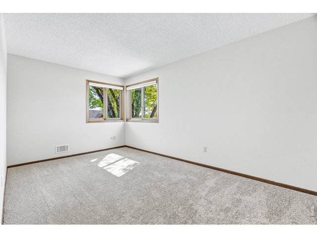 Property Photo 34 Generous bedroom layout with ample wall space for furniture.