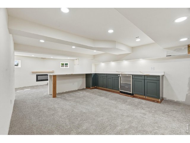 Property Photo 46 Wet bar with cabinetry and beverage fridge-great foundation for an entertaining space.