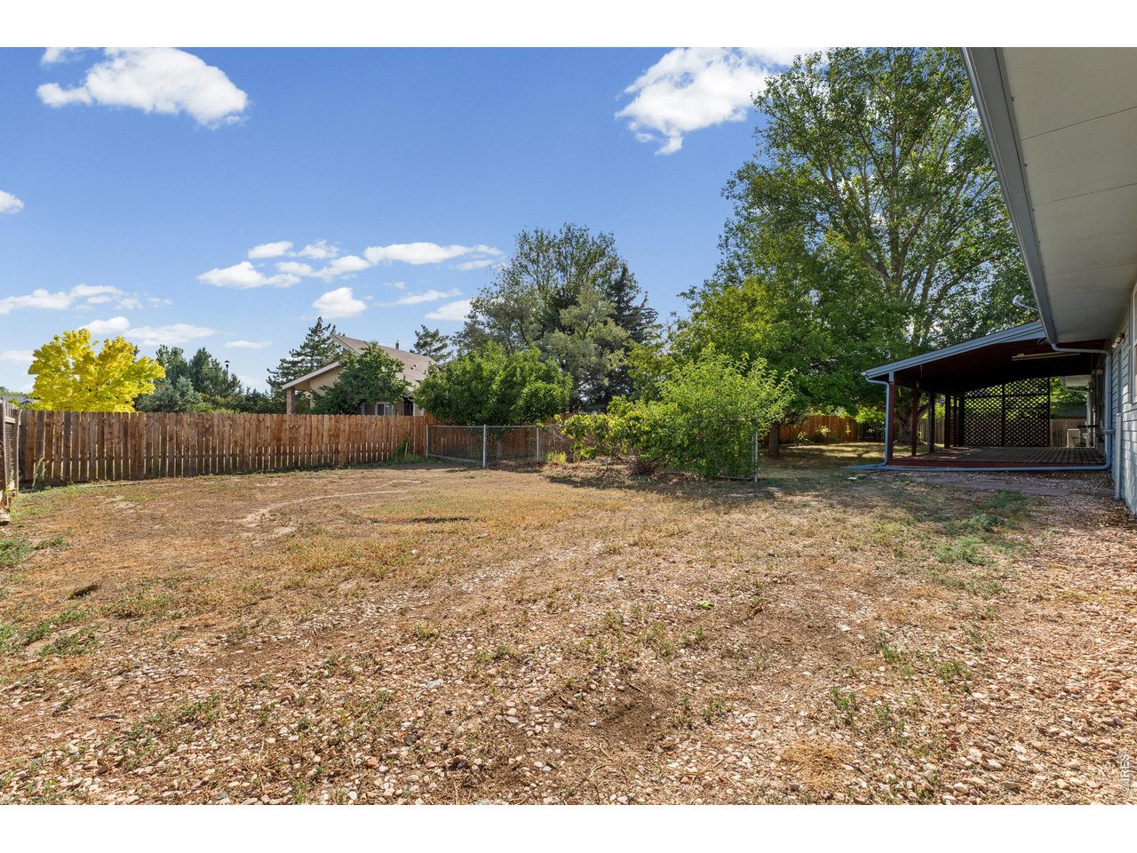 Property Photo 32 1/4 acre lot with mature trees and RV gate and storage area.