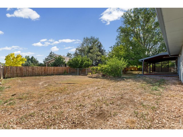 Property Photo 32 1/4 acre lot with mature trees and RV gate and storage area.